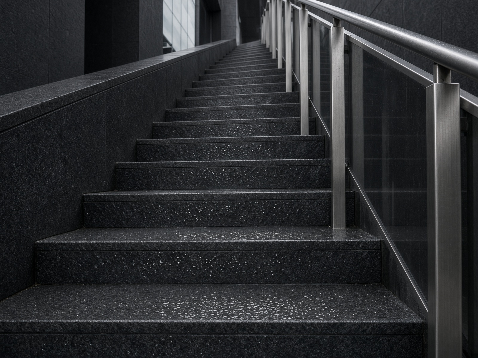 Rain-damp public staircase with a discreet graphite grip texture on the treads